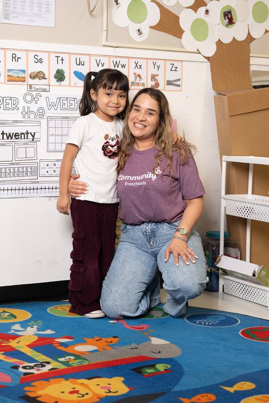 A Pasadena student and teacher smiling together in the classroom